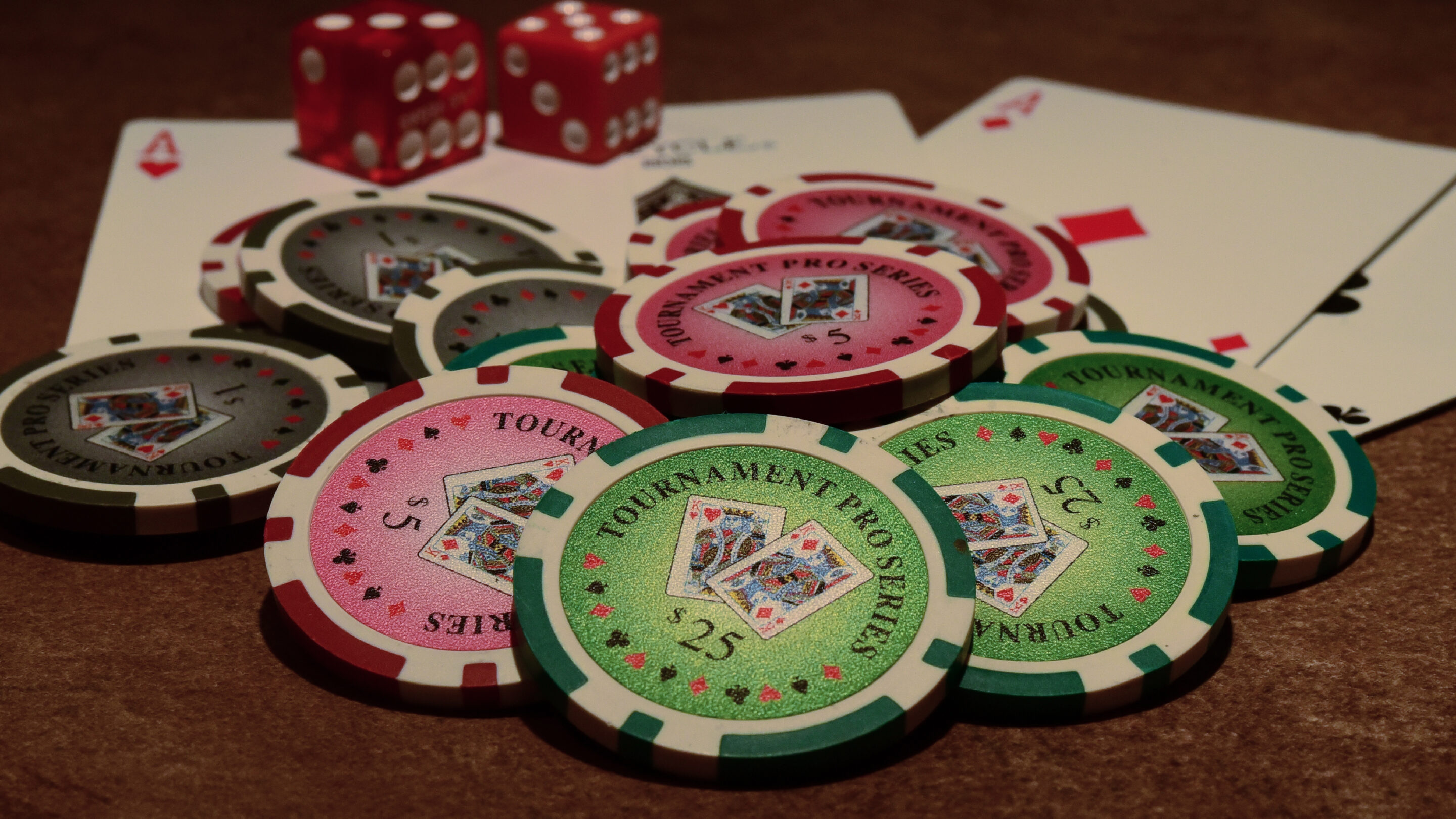 Playing cards, chips and dice illustrating live casino table game design and player experience