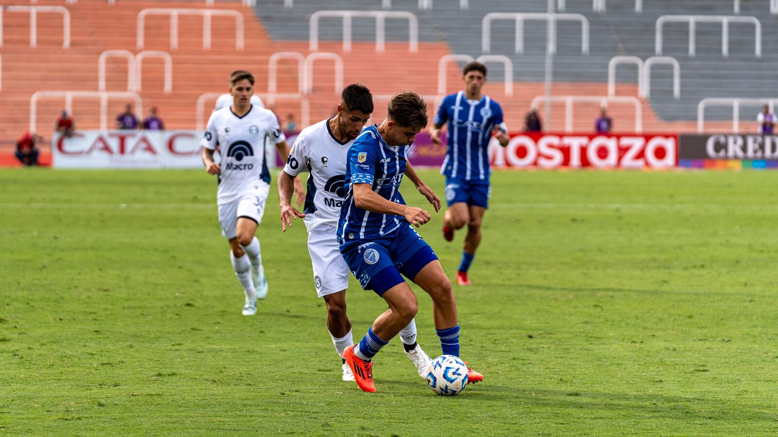 Football players challenging for possession during a match for the Australia vs Türkiye World Cup preview