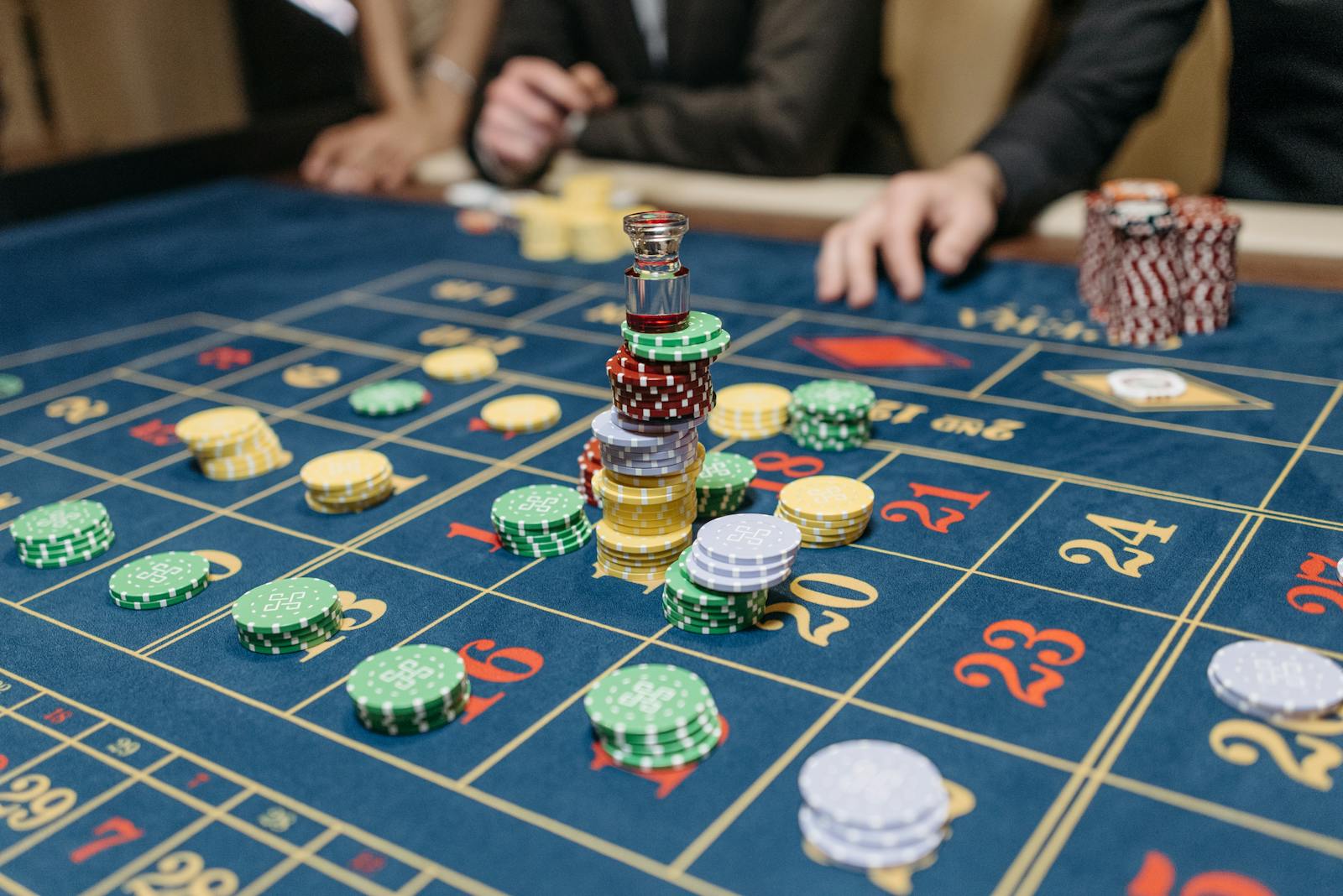 Stacks of casino chips on a roulette table