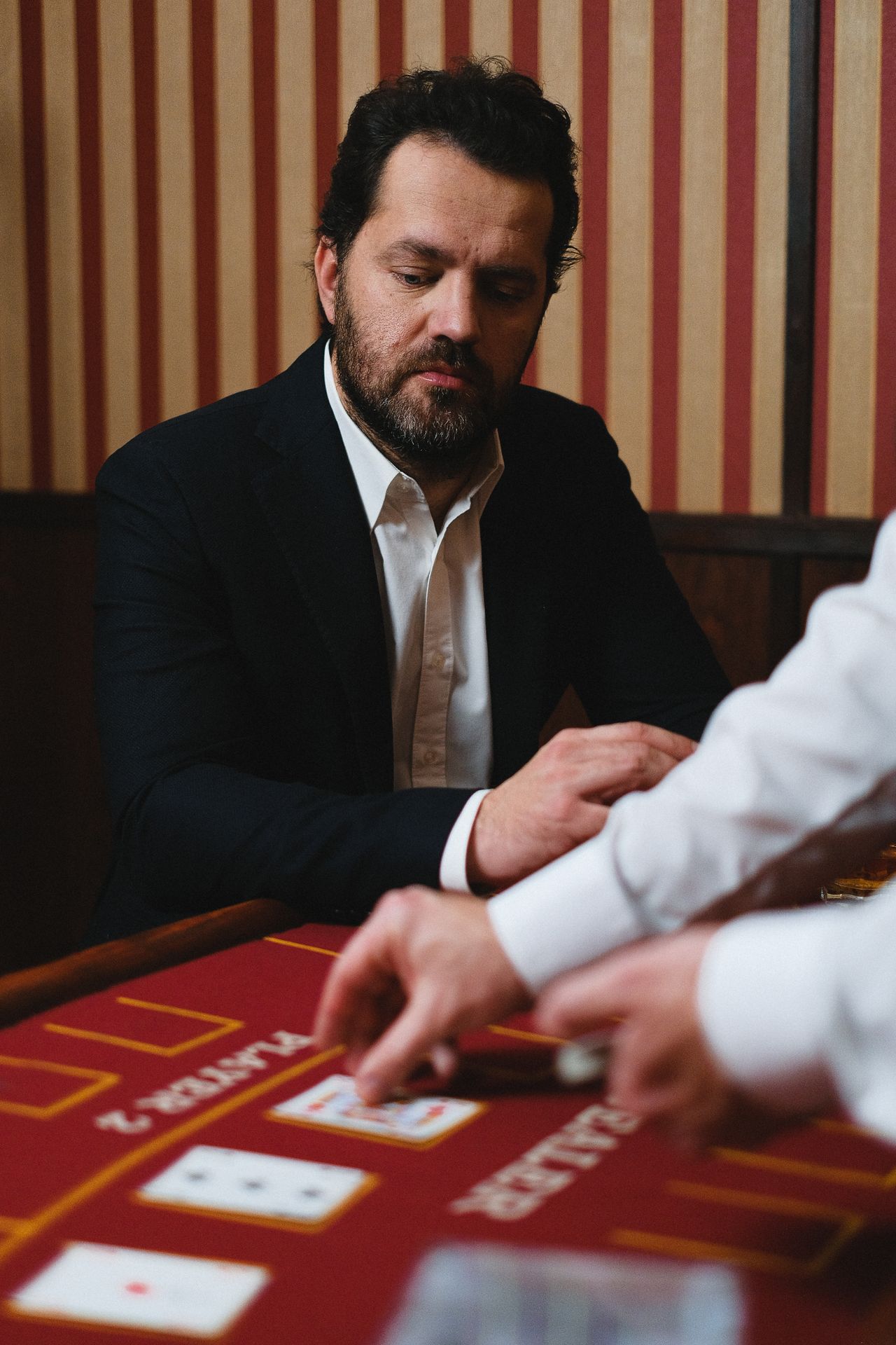 Player at a real casino card table for game rules guide