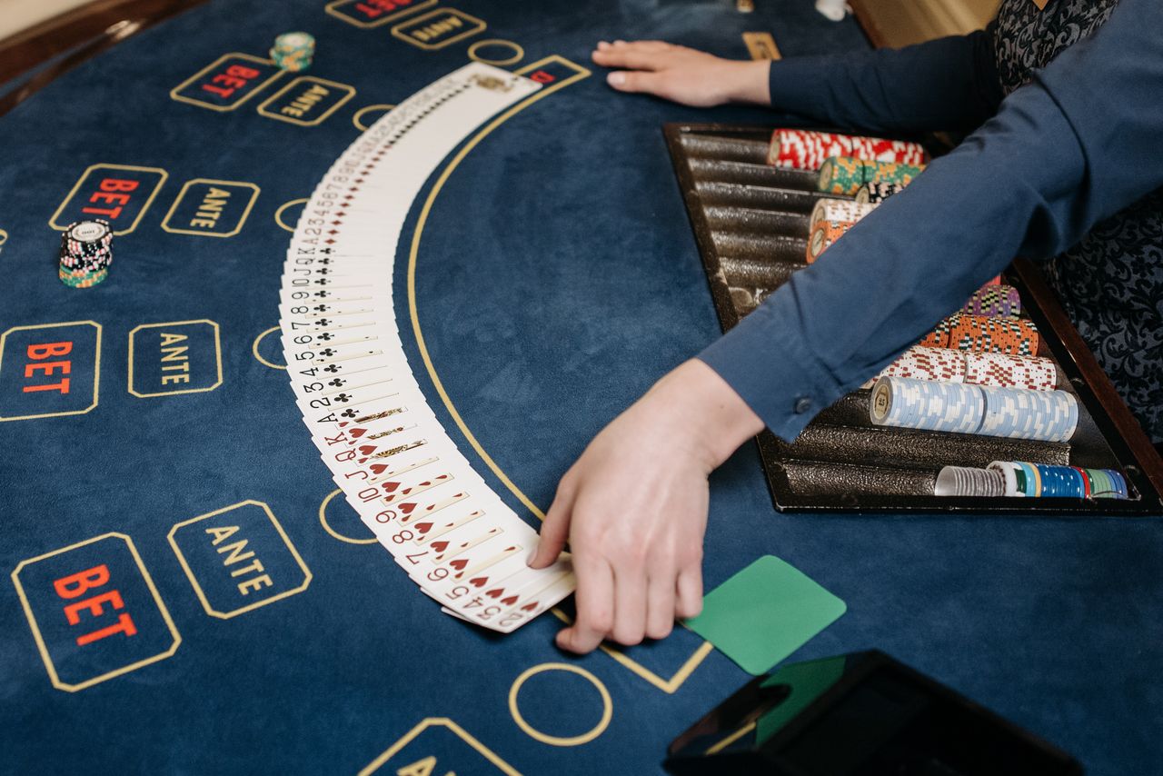 Dealer spreading cards on a casino table for house edge guide