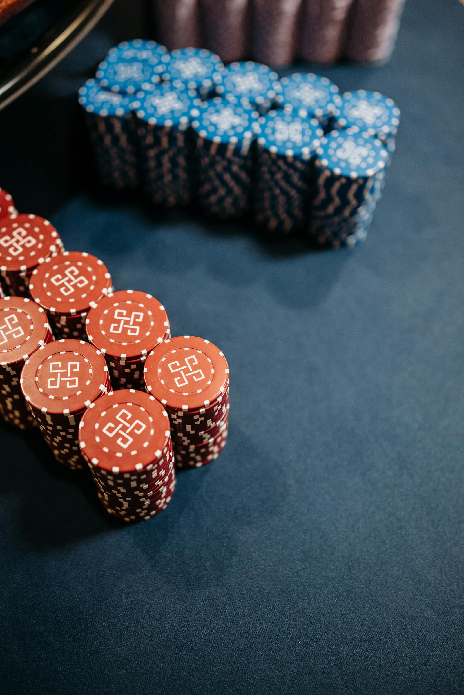 Casino chips stacked beside a roulette wheel