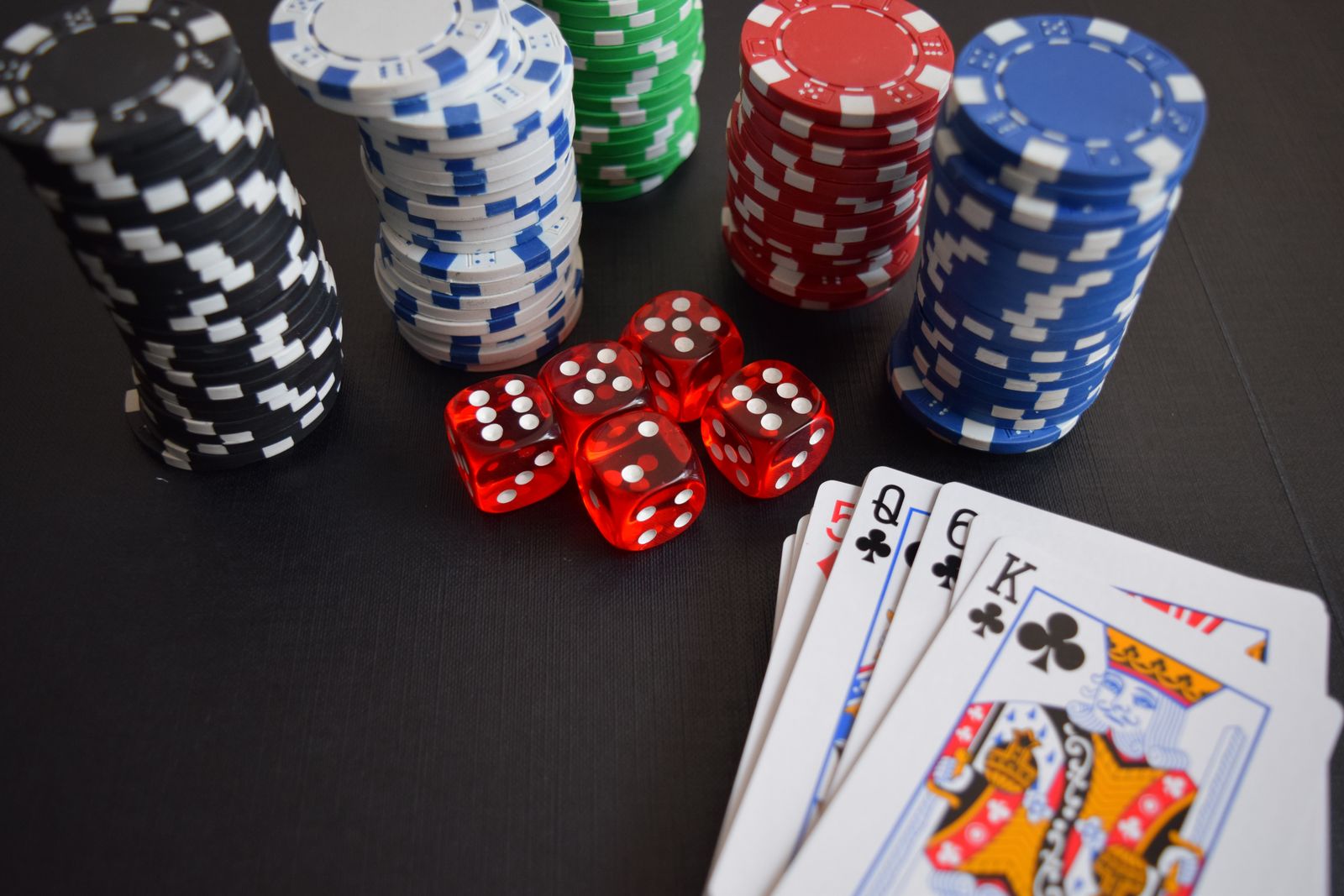 Playing cards, dice and poker chips on a casino table