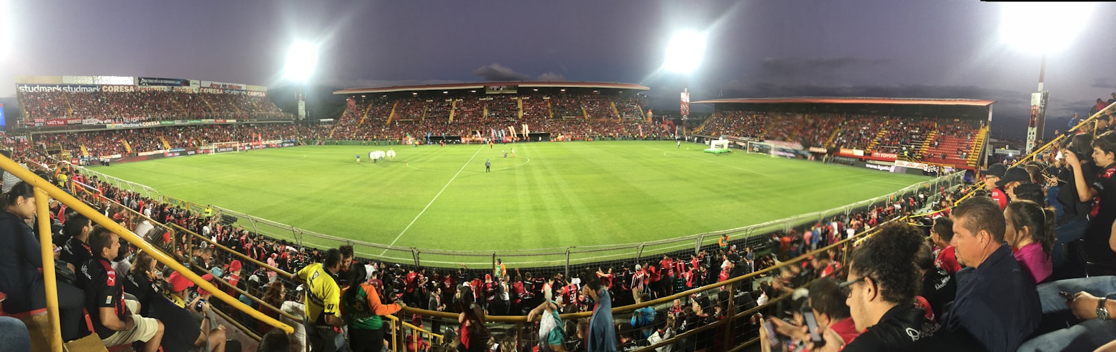 Floodlit football stadium during a World Cup match night