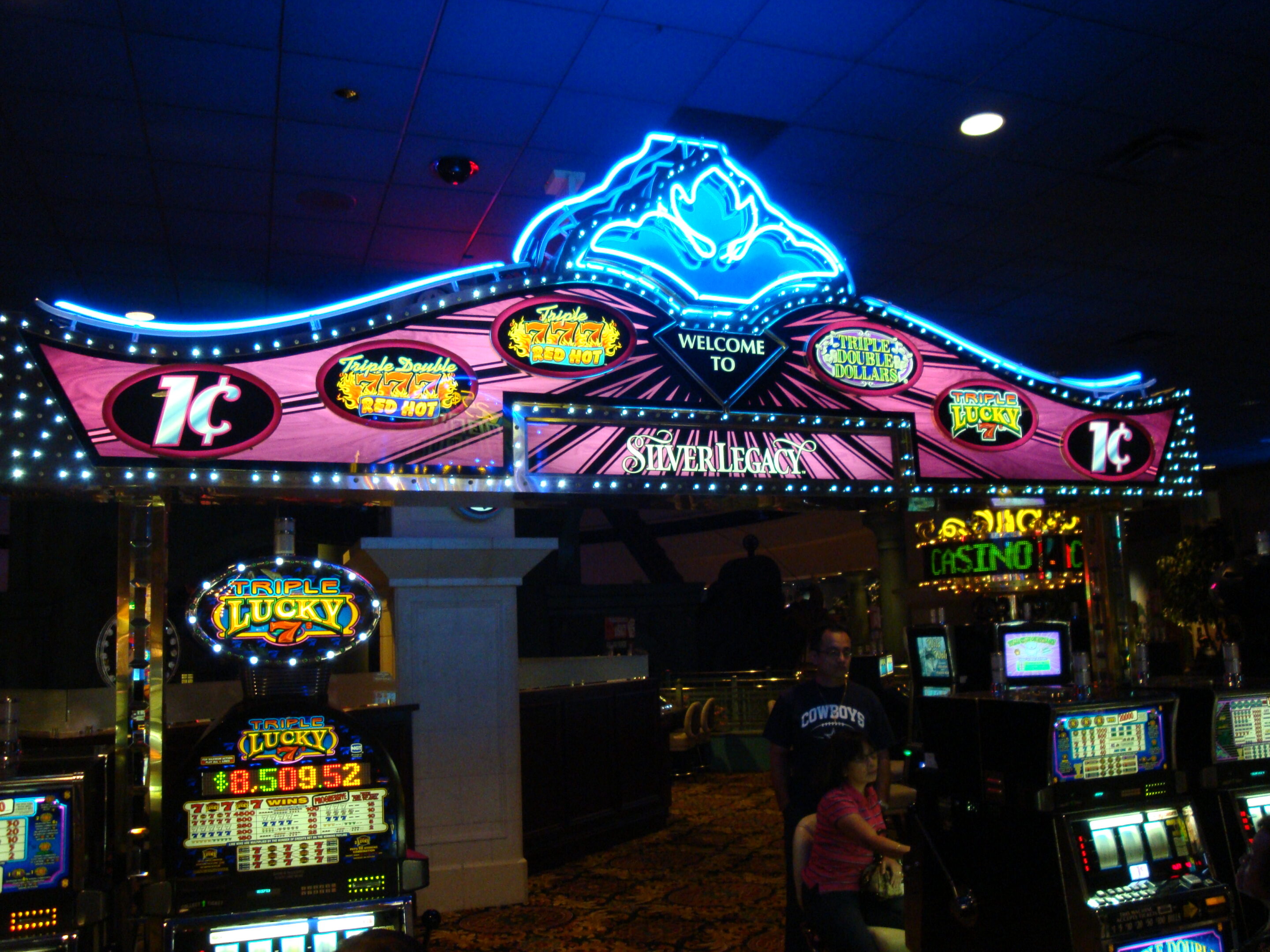 Row of glowing slot machines inside a casino for RTP and volatility explanation