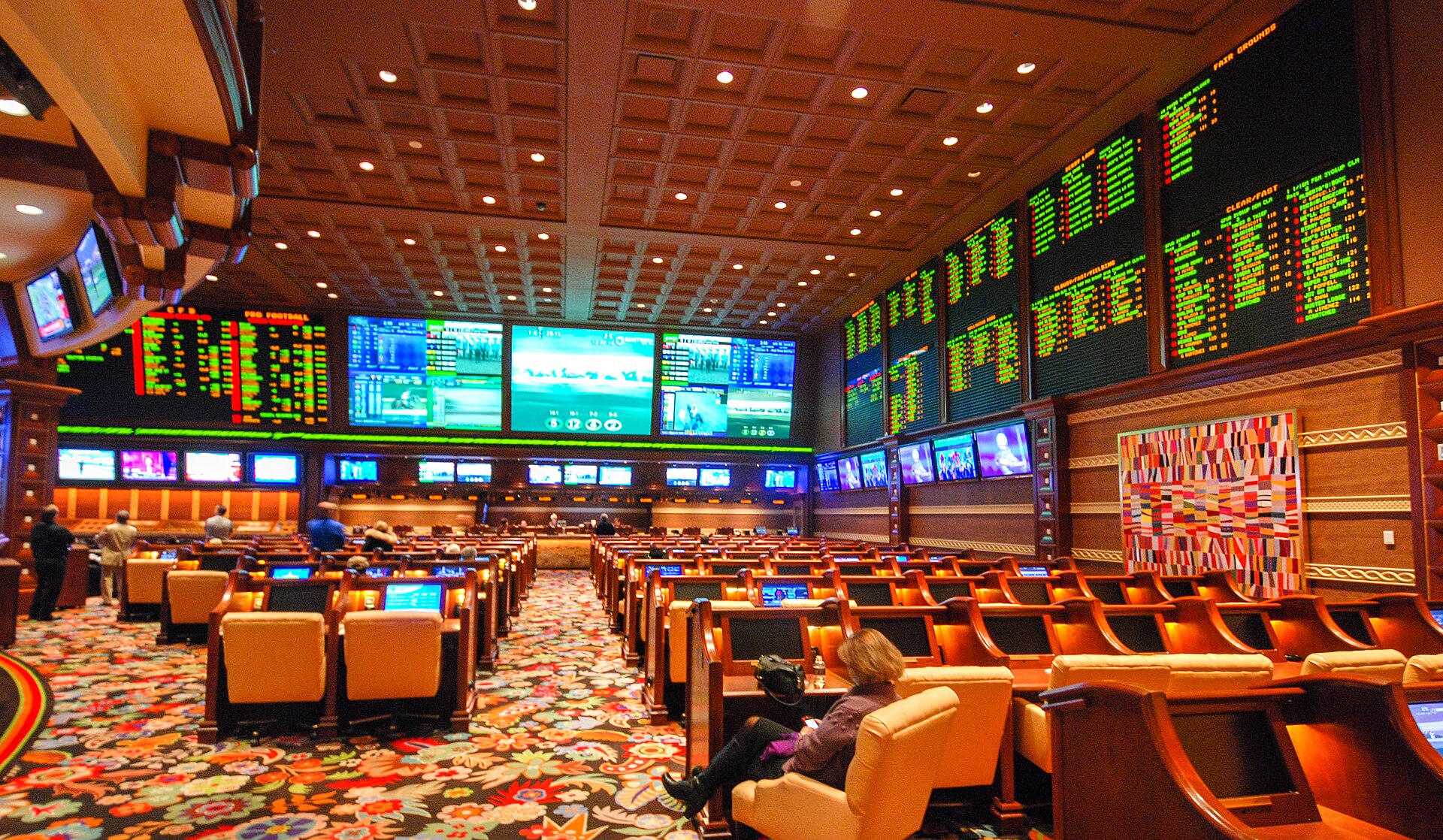 Wynn Las Vegas sportsbook screens representing betting exchange versus sportsbook markets