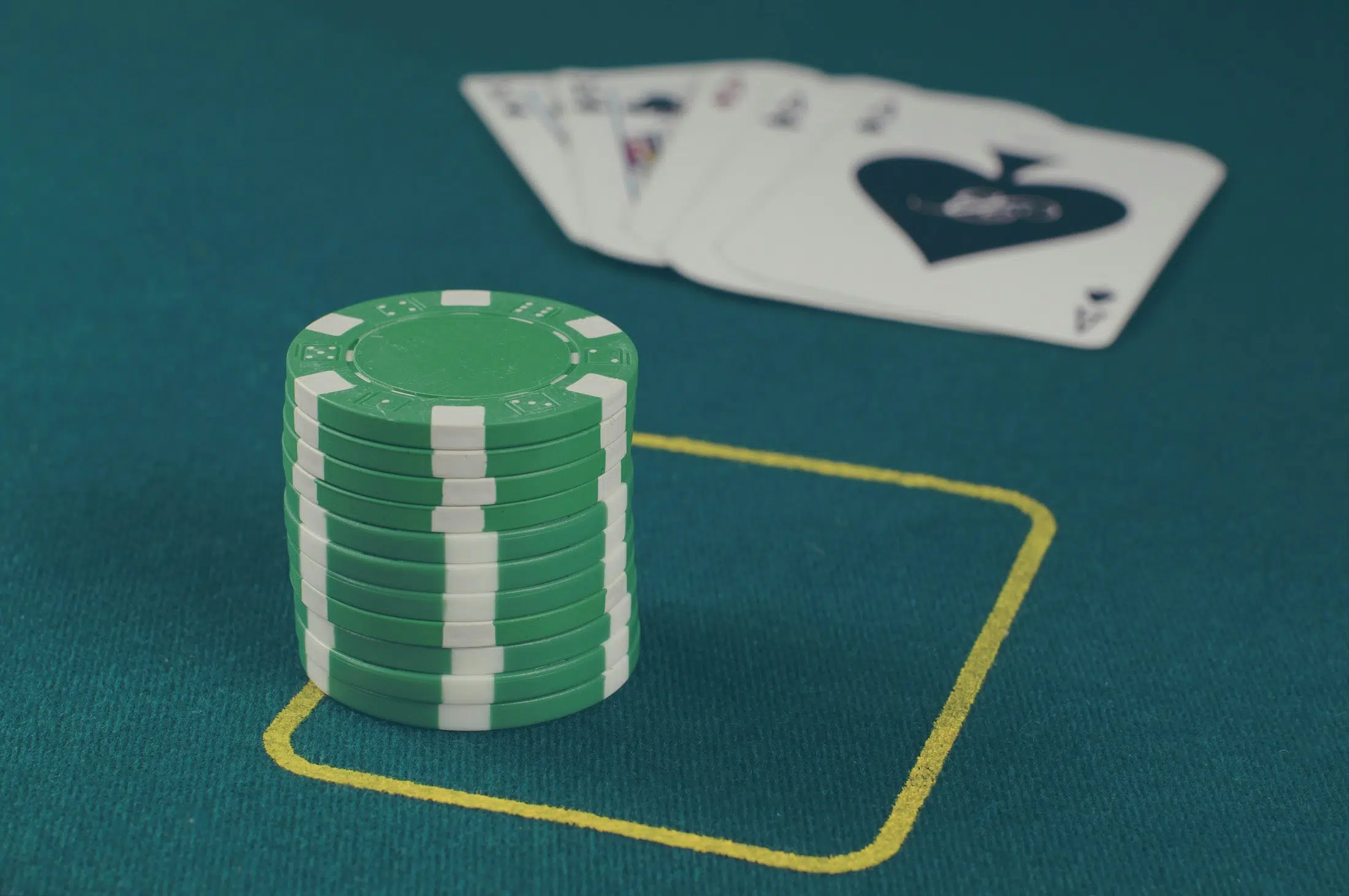 Casino chips and playing cards representing credit card casino deposit risk