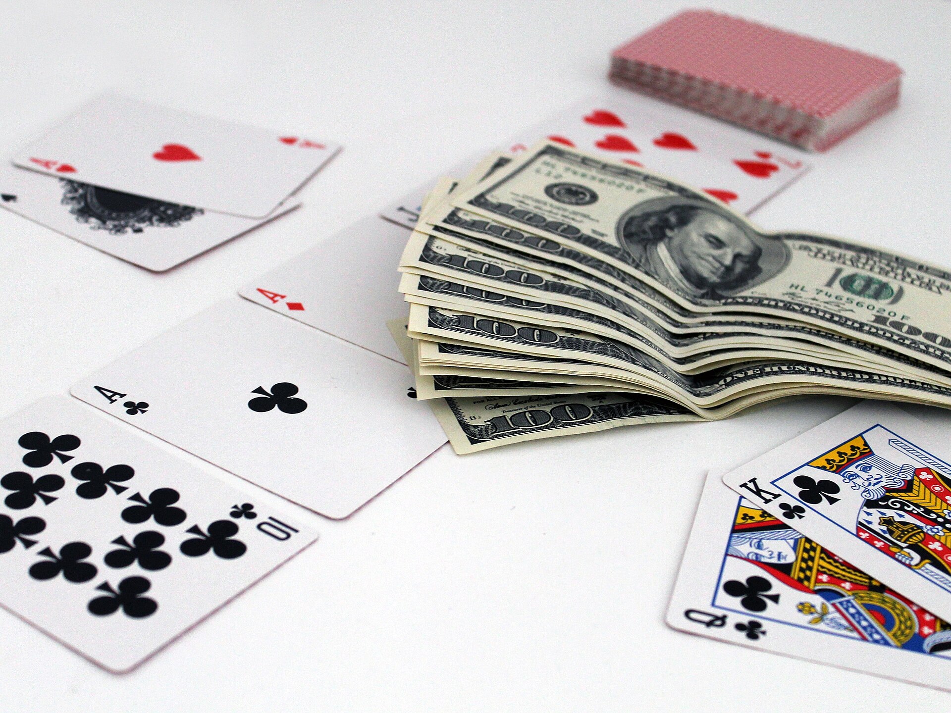 Playing cards cash and chips representing money mule accounts in online gambling