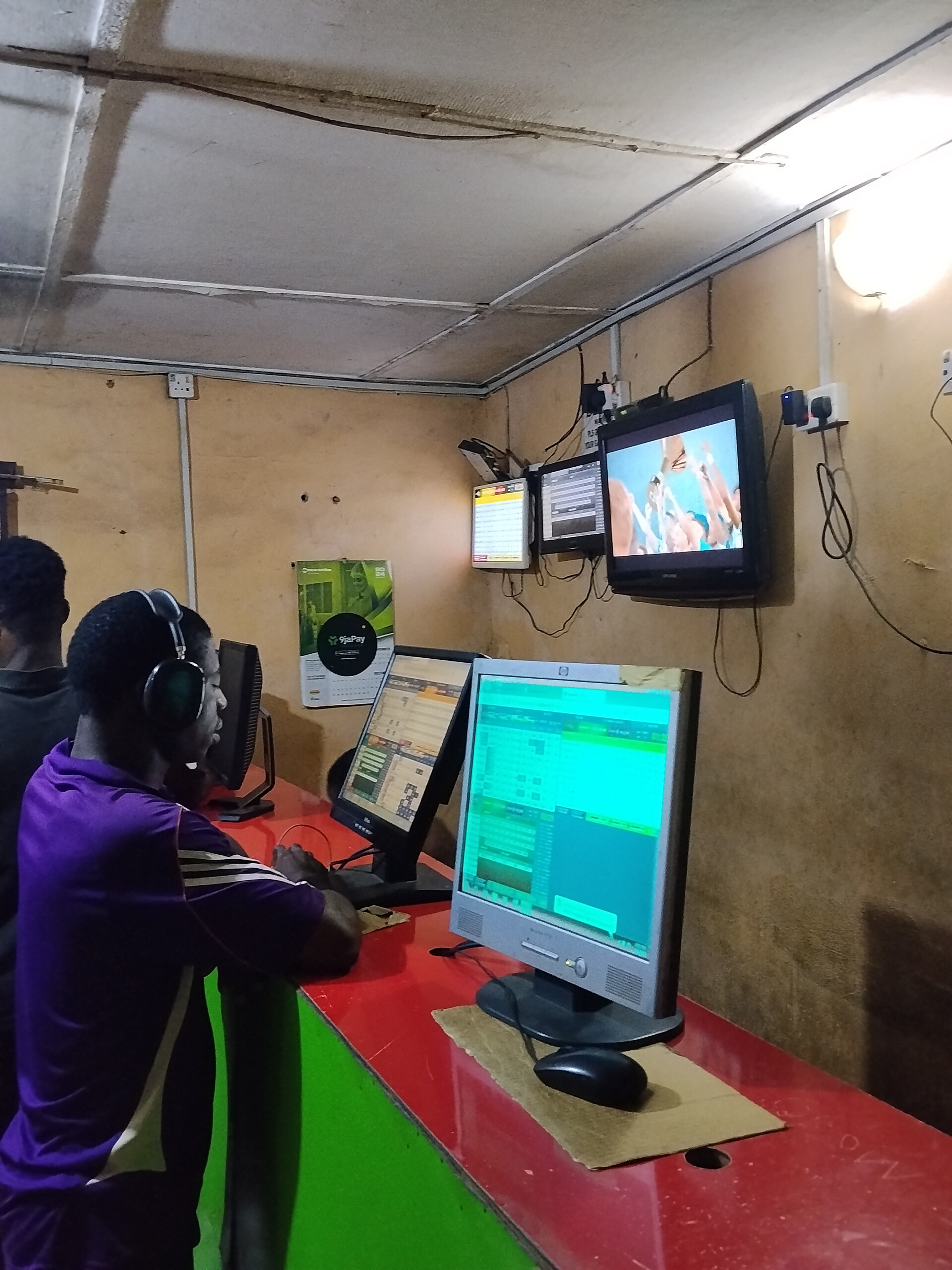 Betting shop customers representing a same-game parlay checklist before football bets