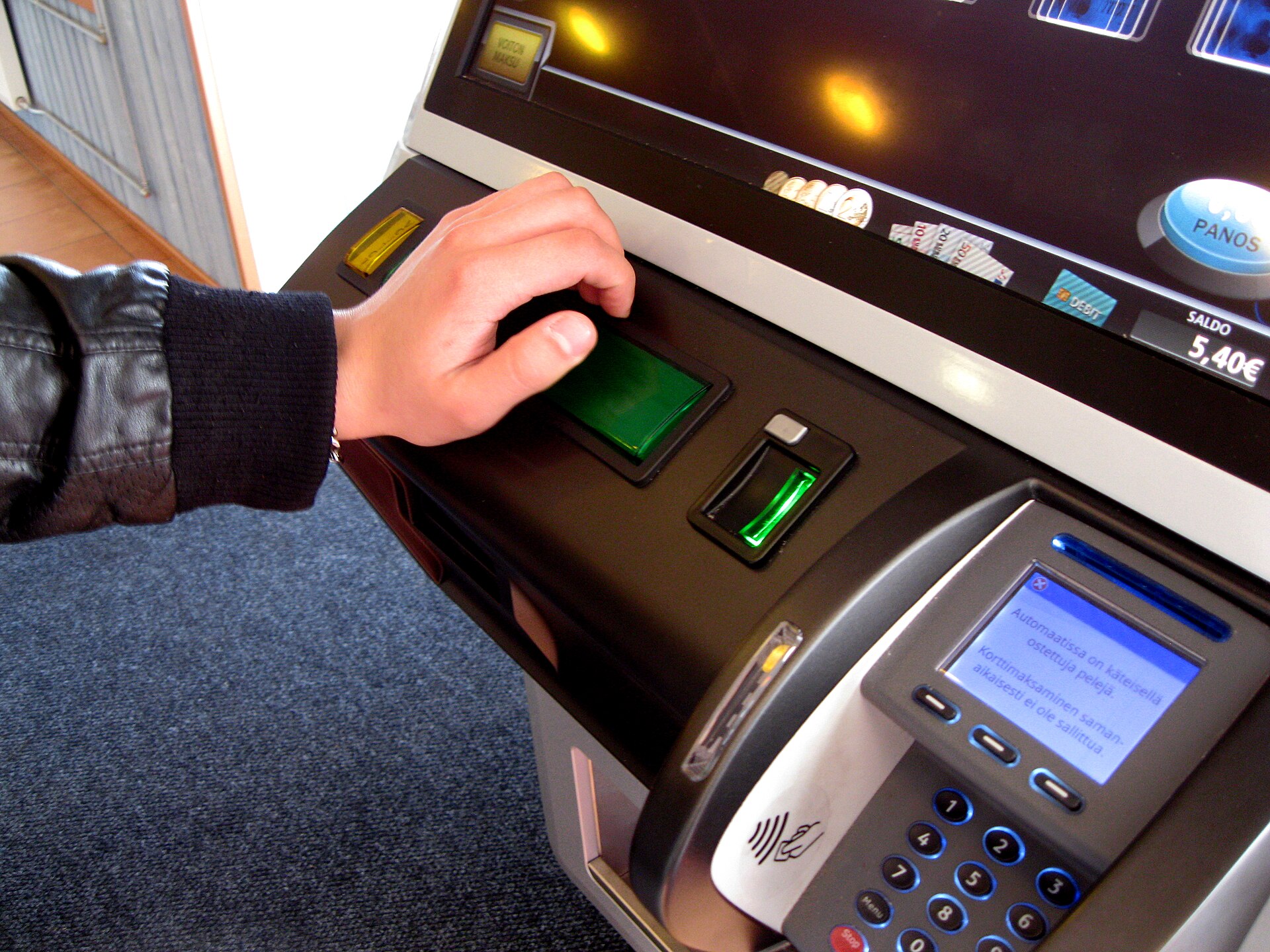 Player using a slot machine representing slot bonus feature rules