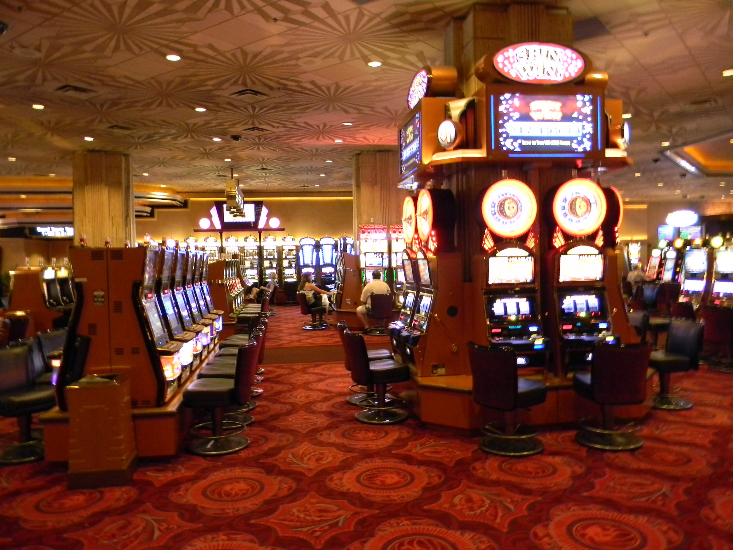 Casino floor with slot machines representing markers of harm in online casino play
