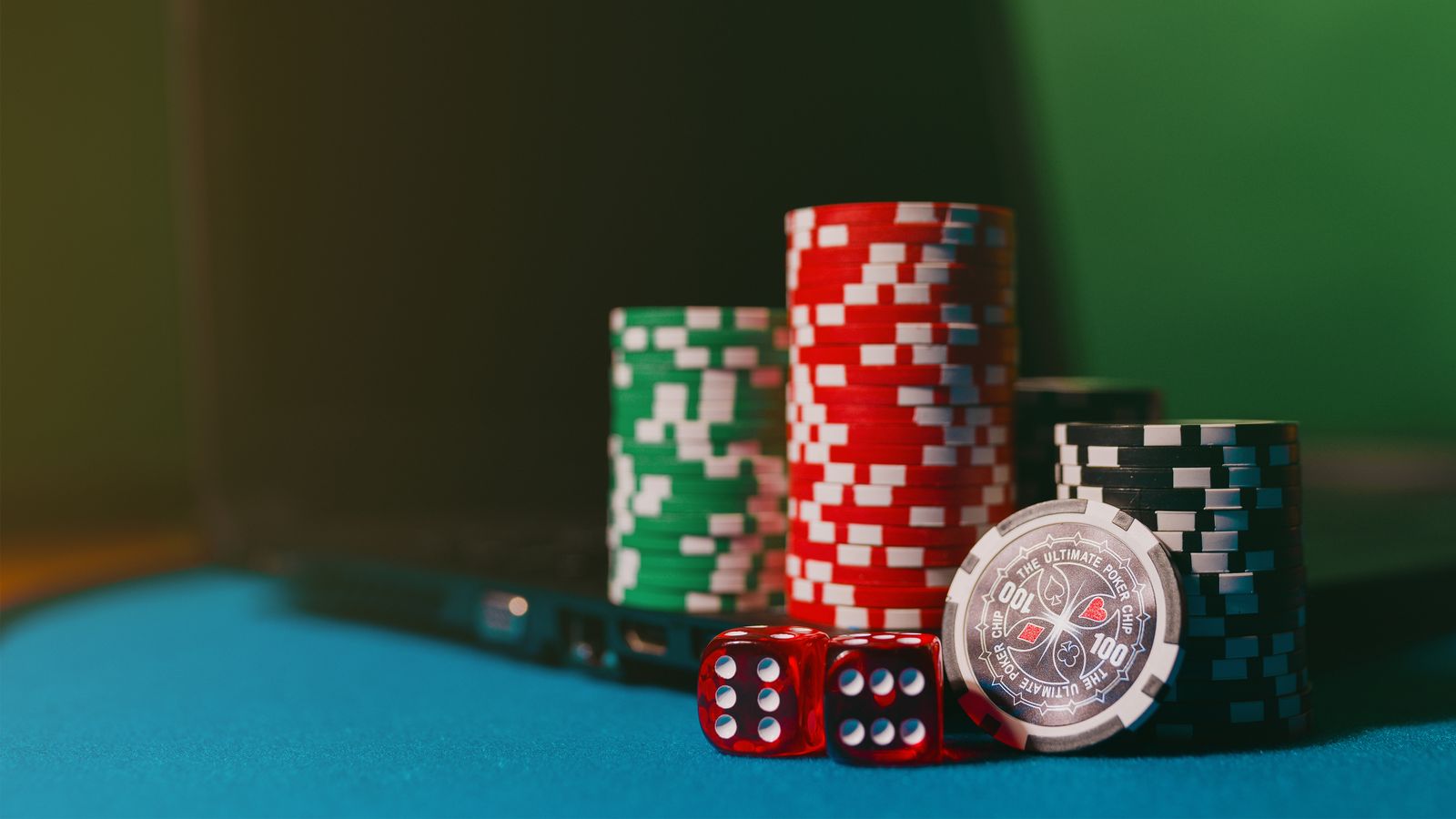 Casino chips beside a laptop representing online gambling age verification controls