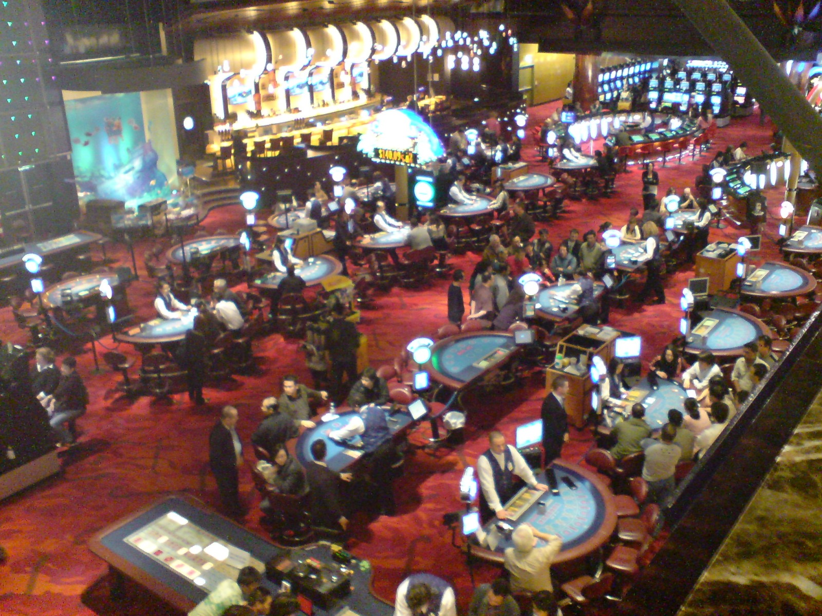 Busy casino table-game floor representing live casino game show mechanics