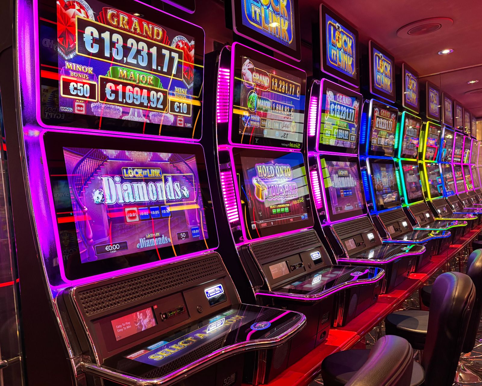 Rows of casino slot machines representing PENN Entertainment retail casino revenue