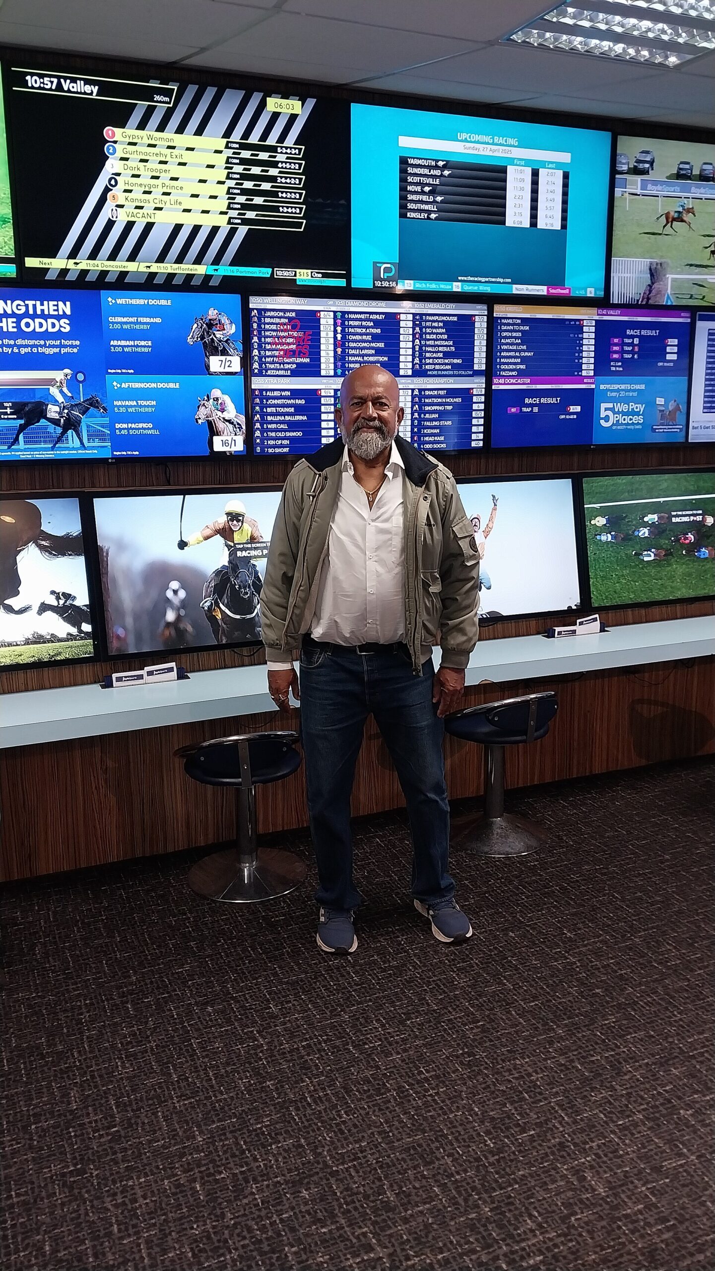 Betting shop screens showing racing odds and upcoming events