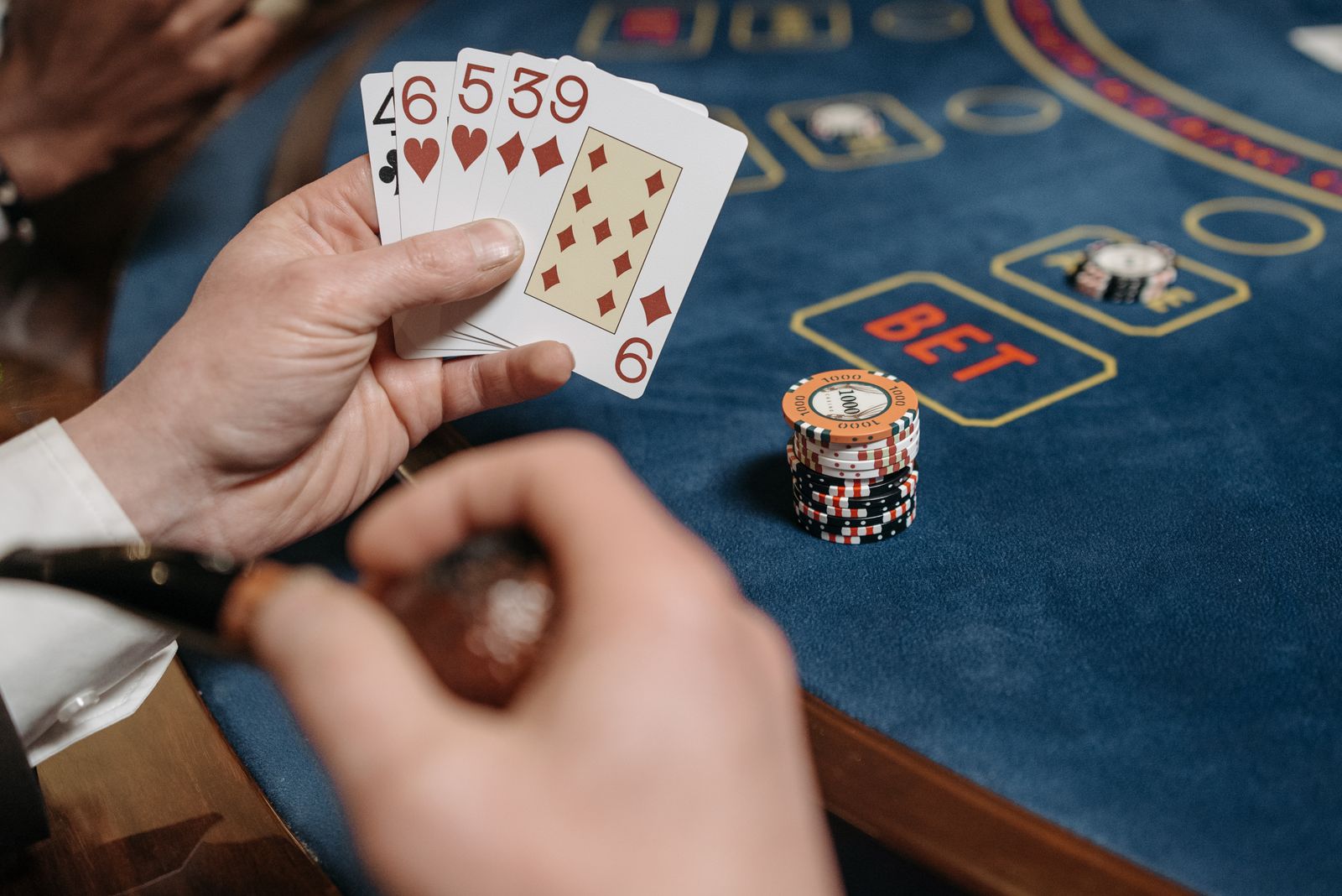 Baccarat table with cards and chips representing baccarat commission