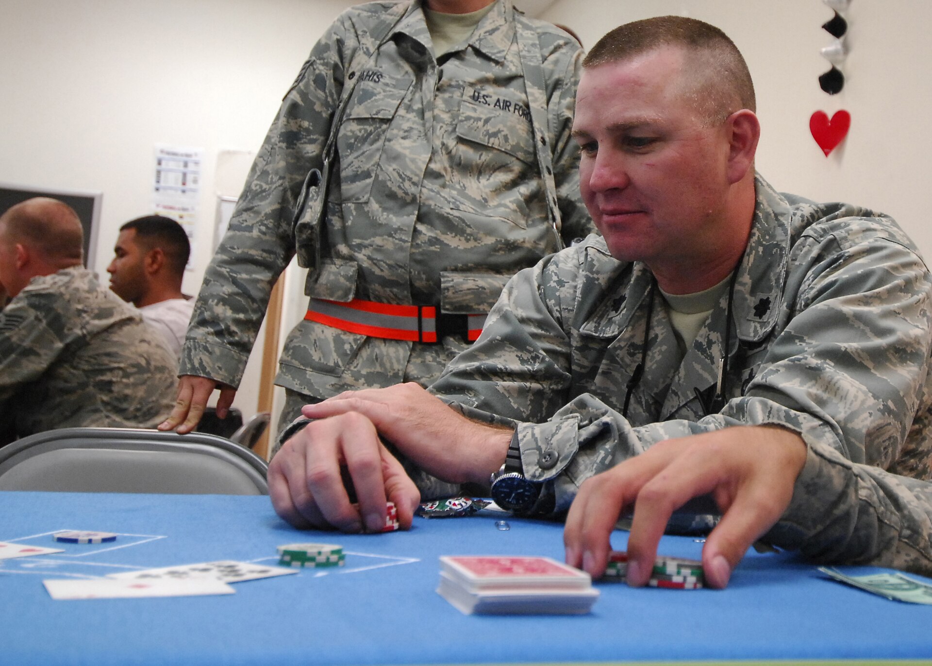 Players at a blackjack table with cards and chips