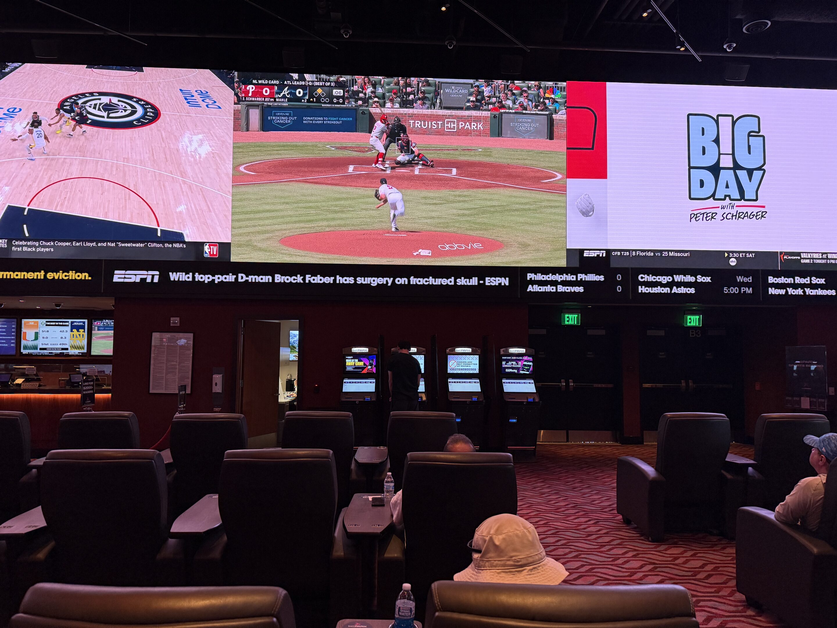 BetParx sportsbook with betting kiosks and game screens during a Philadelphia Phillies playoff game