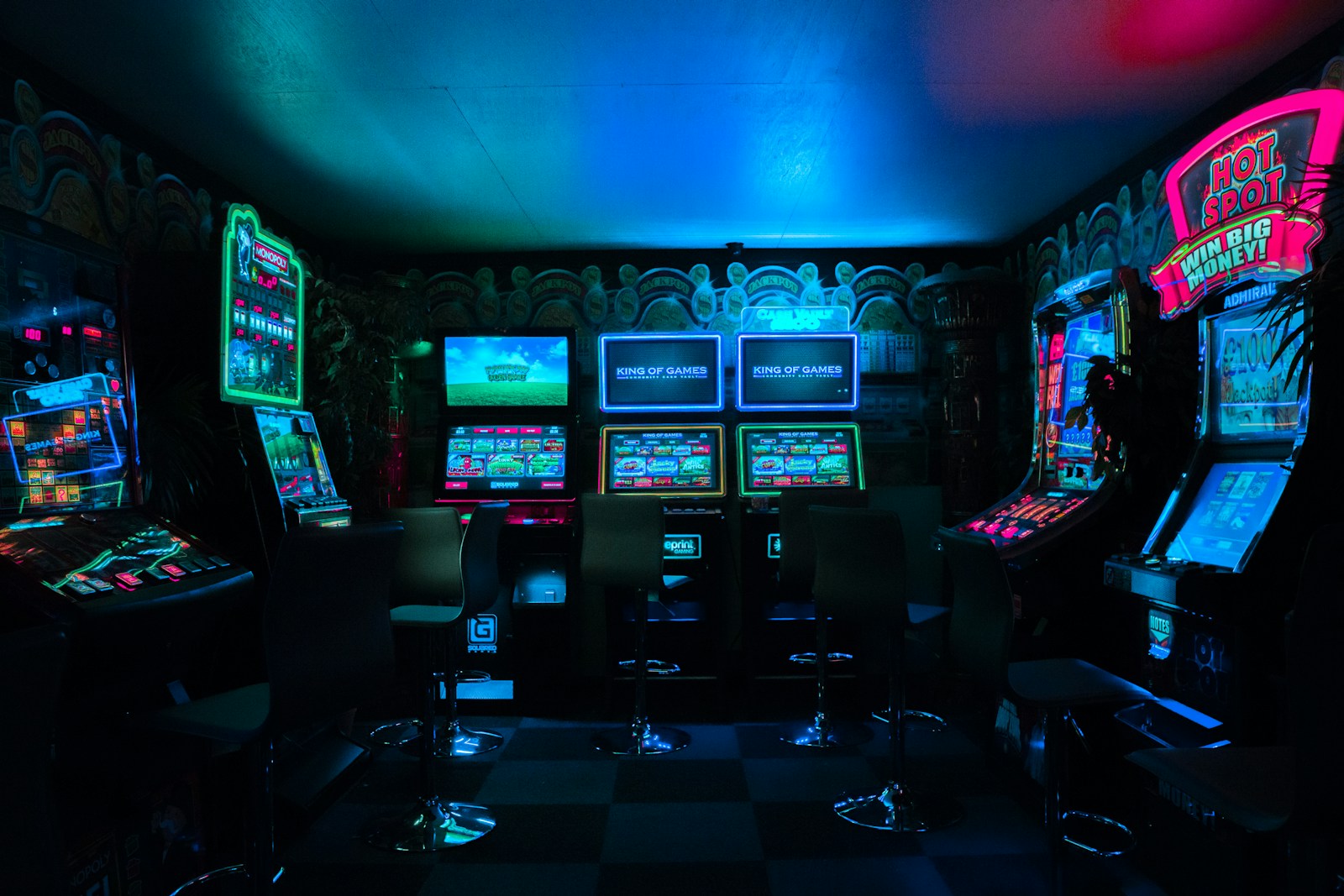 Rows of casino slot machines with illuminated screens