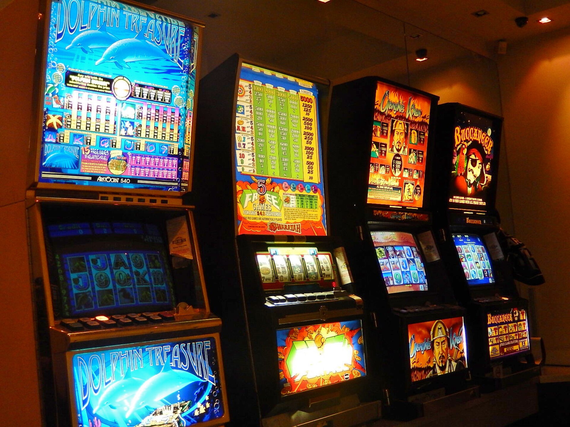 Casino slot machines displaying symbols and payout information